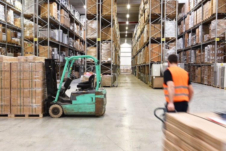 forklist and worker in an industrial warehouse